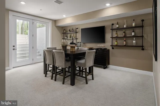a view of a dining room with furniture and a flat screen tv