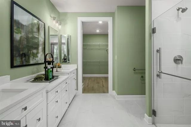 a bathroom with a granite countertop shower sink and mirror