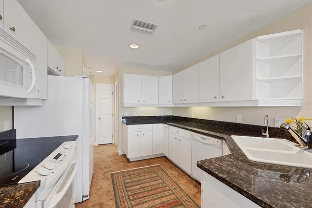a bedroom with two beds and a chandelier