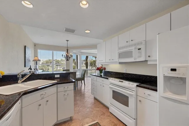 a living room with furniture ceiling fan and a large window