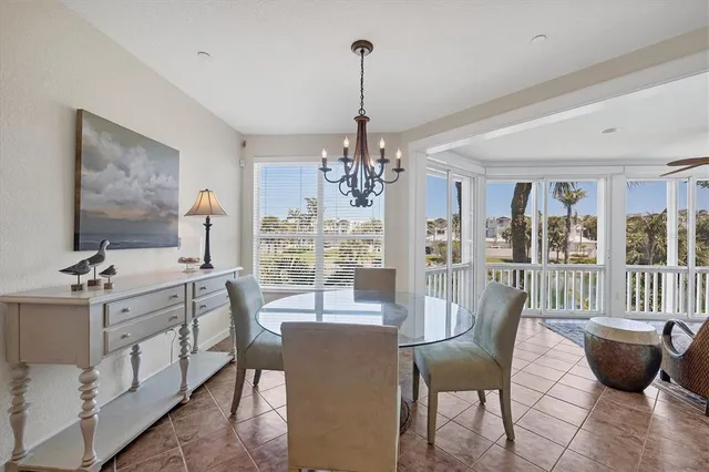 a view of a house with a yard and potted plants