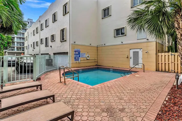 a view of a swimming pool with a lounge chairs