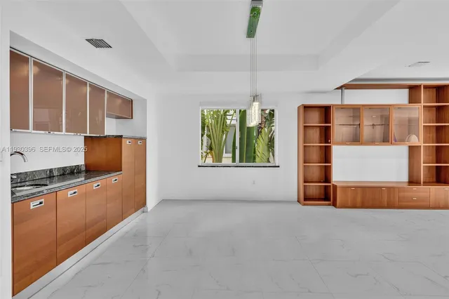 a large kitchen with stainless steel appliances granite countertop a refrigerator and a sink