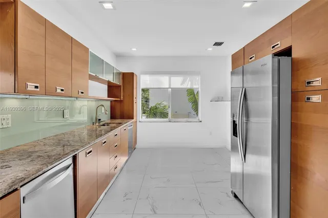a kitchen with stainless steel appliances granite countertop a sink and stove top oven