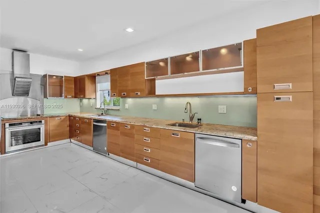 a kitchen with granite countertop a stove and a sink