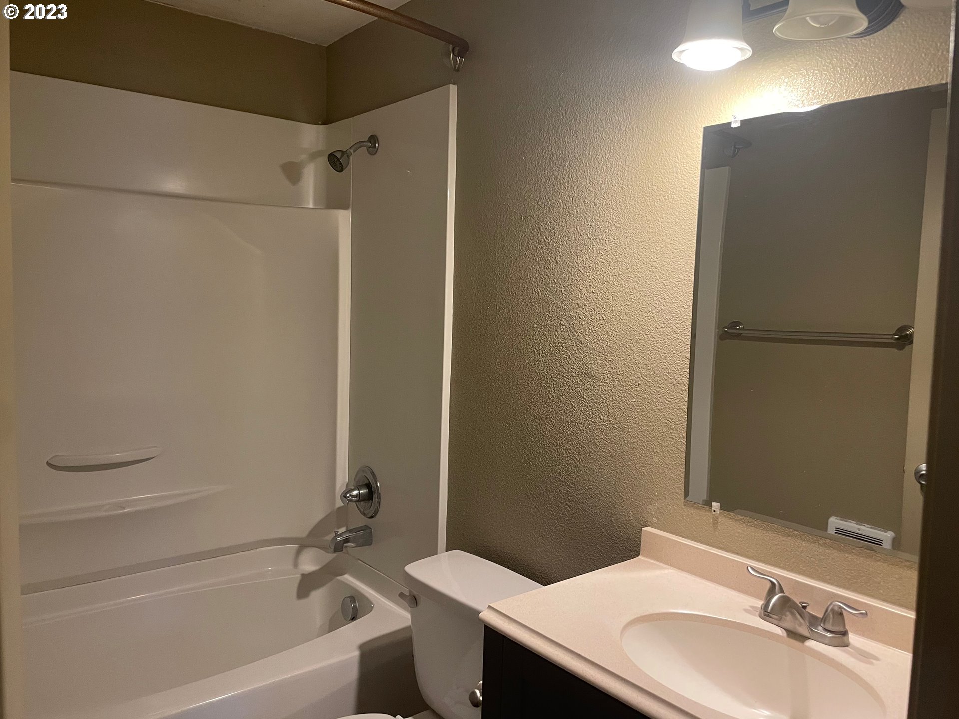 3205 W Street Vancouver, WA 98663 - Photo 6 of 6 a bathroom with a granite countertop sink toilet and shower