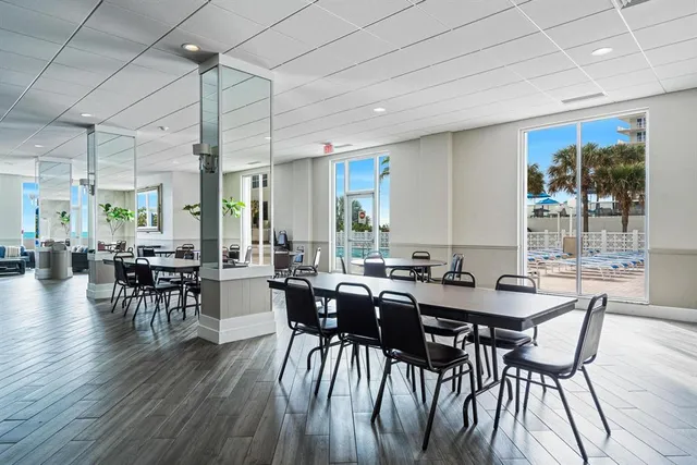 a view of a dining room with furniture window and wooden floor