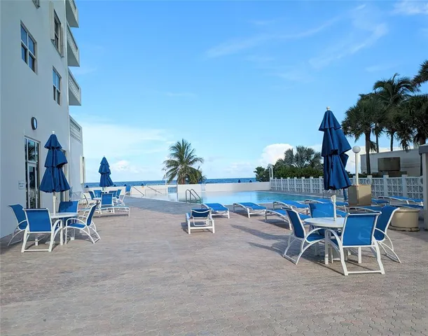 a view of a patio with table and chairs and potted plants