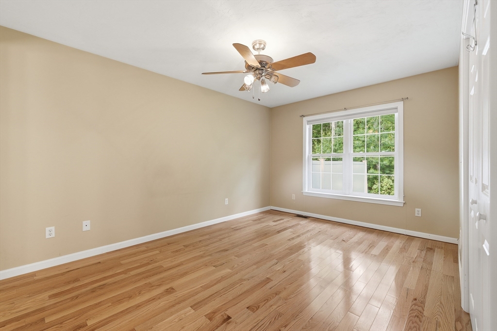 9 Rock Marsh Road, Unit B Wareham, MA 02571 - Photo 22 of 41 a view of an empty room with wooden floor and a window