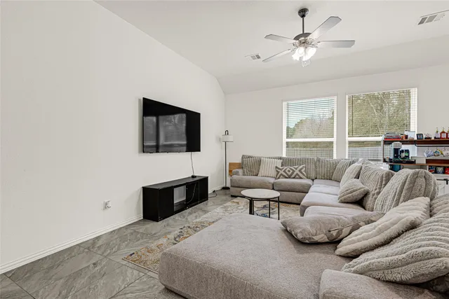 a living room with furniture and kitchen view