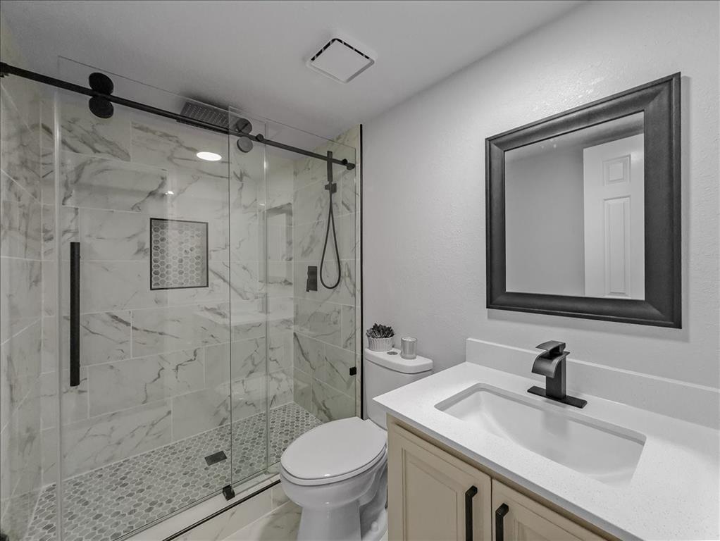 136 Southwest Rand Drive Burleson, TX 76028 - Photo 16 of 25 a bathroom with a sink a toilet and shower