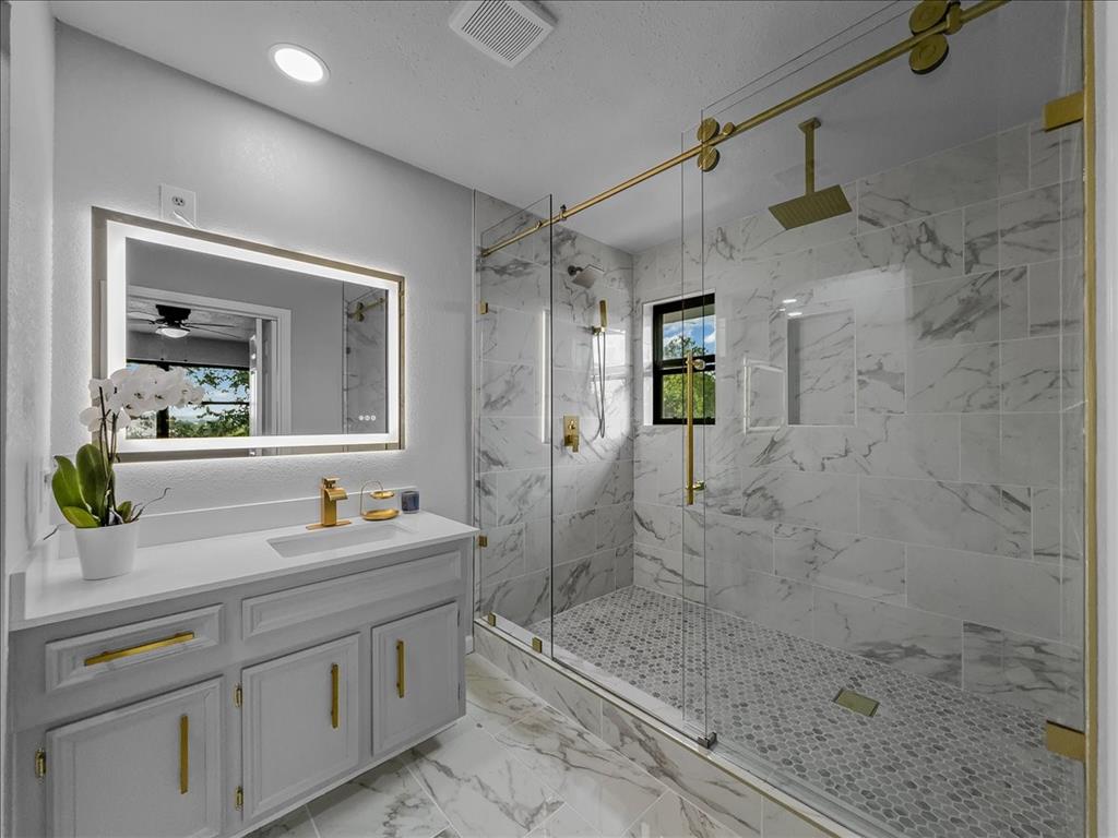 136 Southwest Rand Drive Burleson, TX 76028 - Photo 19 of 25 a spacious bathroom with a sink shower and a mirror