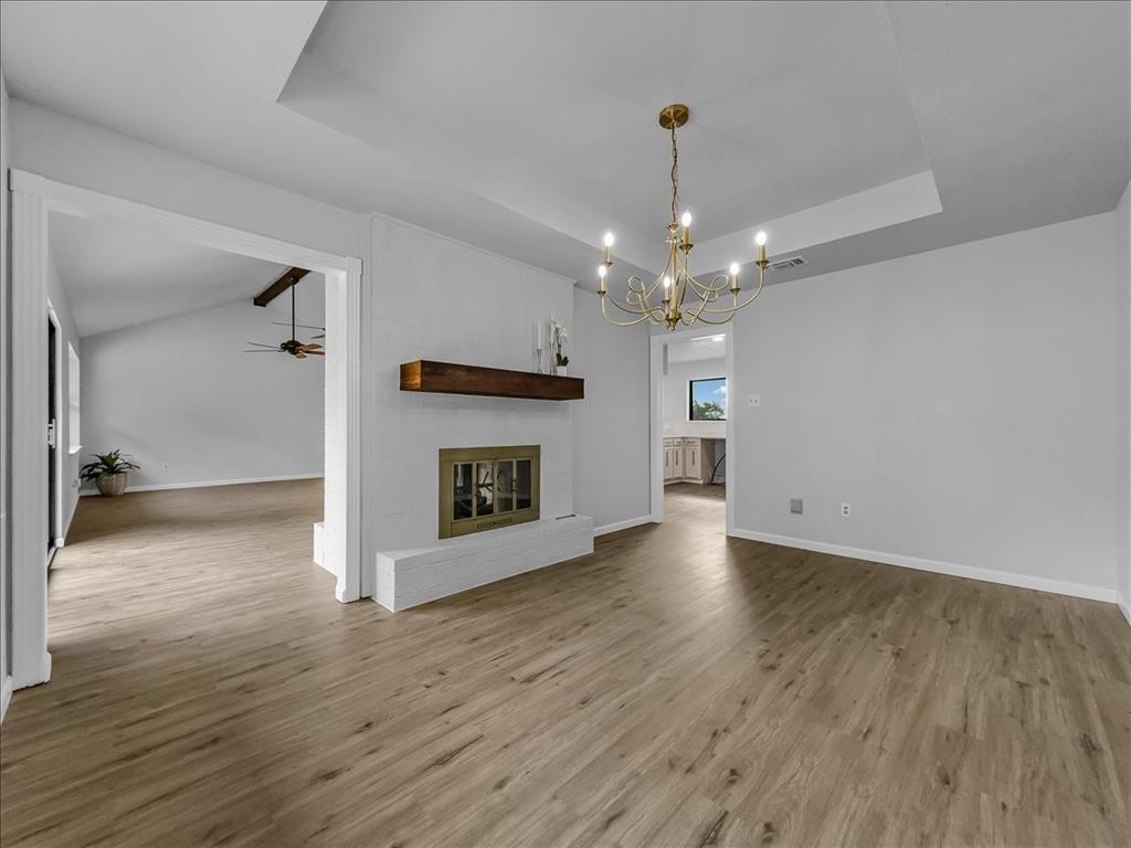 136 Southwest Rand Drive Burleson, TX 76028 - Photo 2 of 25 a view of a room with wooden floors and kitchen view