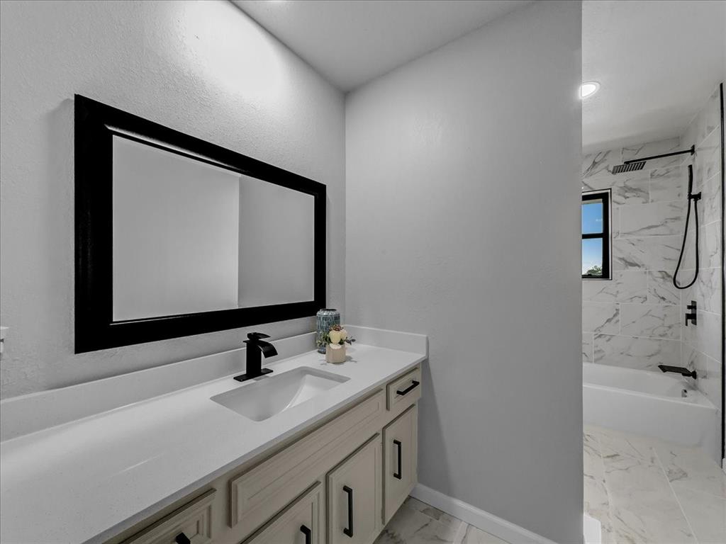 136 Southwest Rand Drive Burleson, TX 76028 - Photo 21 of 25 a bathroom with a sink and a mirror