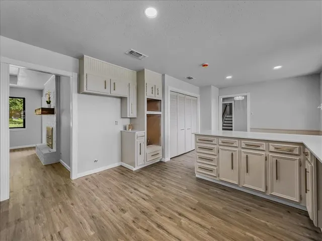 a kitchen with stainless steel appliances granite countertop a refrigerator and a stove top oven