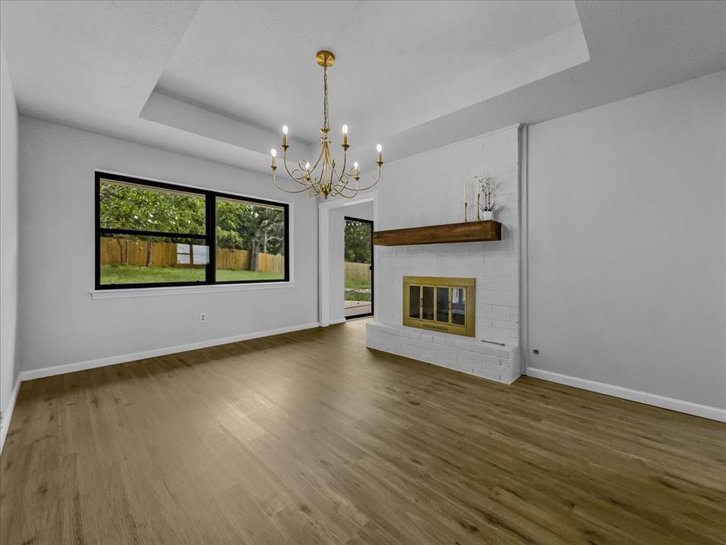 136 Southwest Rand Drive Burleson, TX 76028 - Photo 6 of 25 a view of an empty room with a fireplace and a window