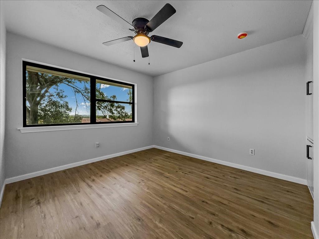 136 Southwest Rand Drive Burleson, TX 76028 - Photo 10 of 25 a view of an empty room with a window and wooden floor