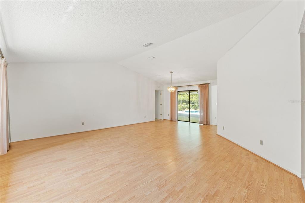 1379 Matthew Avenue Spring Hill, FL 34609 - Photo 11 of 55 an empty room with wooden floor and windows