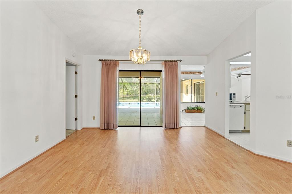 1379 Matthew Avenue Spring Hill, FL 34609 - Photo 12 of 55 a view of an empty room with wooden floor and a window