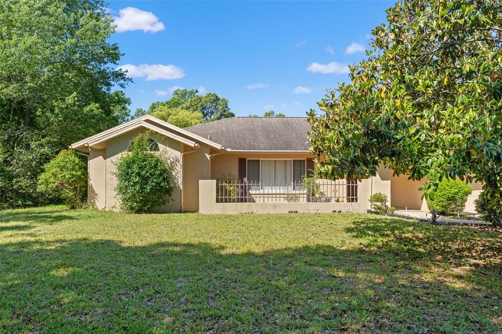 1379 Matthew Avenue Spring Hill, FL 34609 - Photo 2 of 55 a view of a house with a yard and sitting area