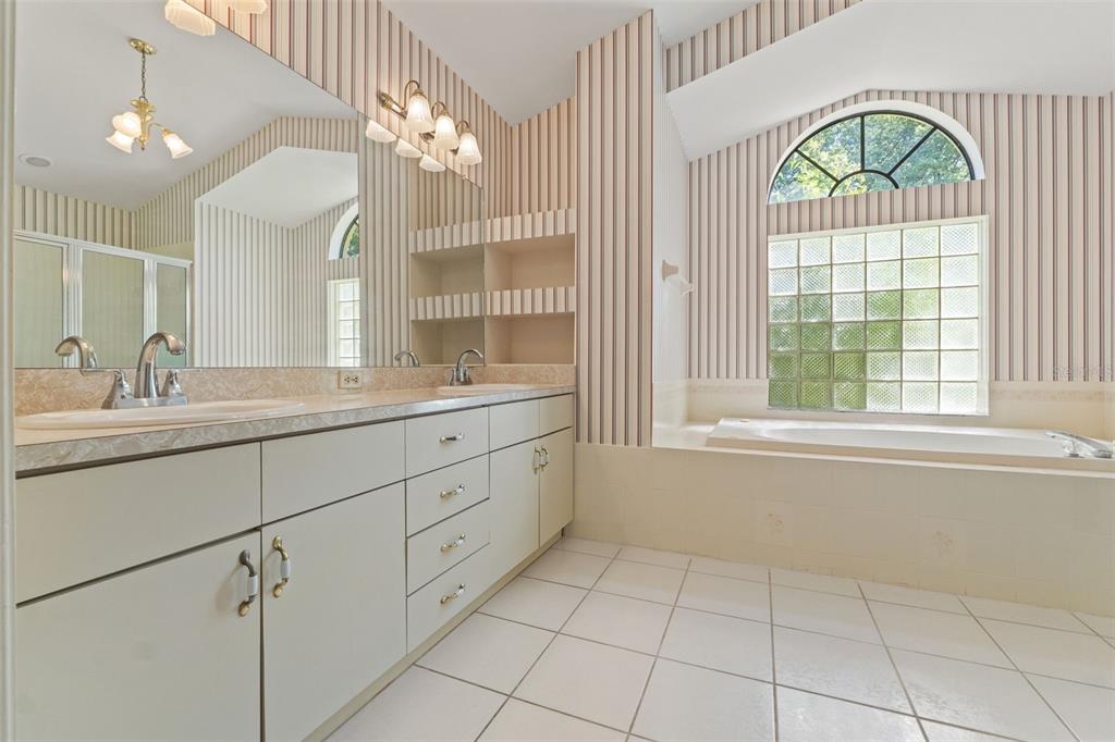 1379 Matthew Avenue Spring Hill, FL 34609 - Photo 30 of 55 a bathroom with a sink a vanity a mirror and a window