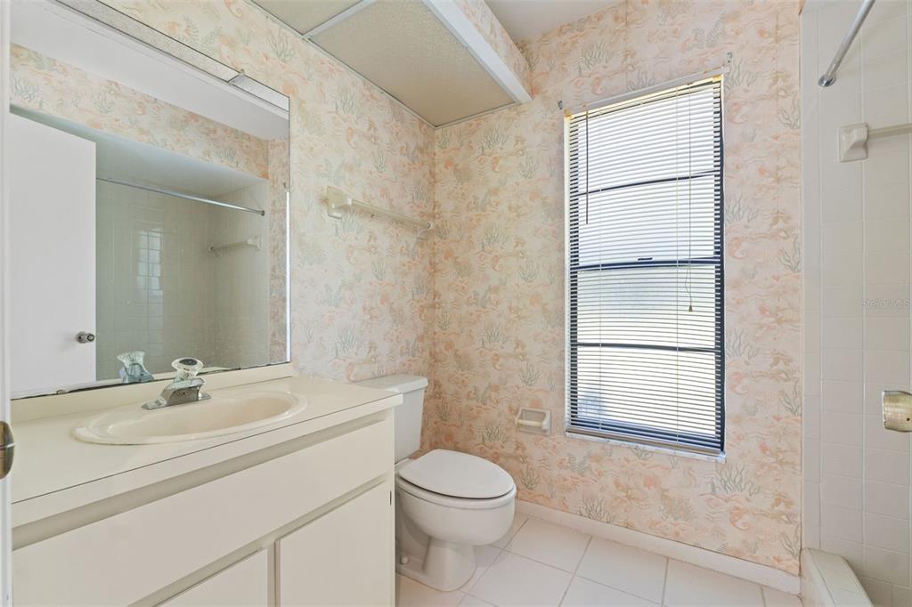 1379 Matthew Avenue Spring Hill, FL 34609 - Photo 36 of 55 a bathroom with a toilet sink vanity and windows