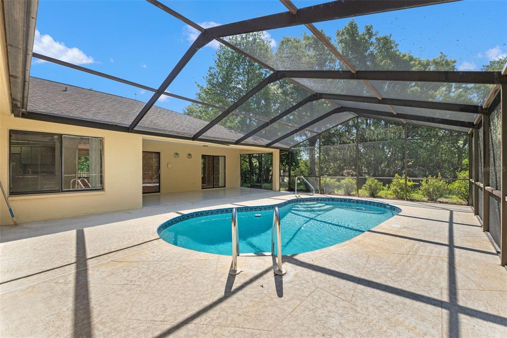 1379 Matthew Avenue Spring Hill, FL 34609 - Photo 45 of 55 a swimming pool with outdoor seating