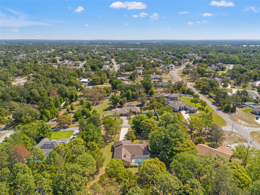 1379 Matthew Avenue Spring Hill, FL 34609 - Photo 7 of 55 an aerial view of residential building with green space