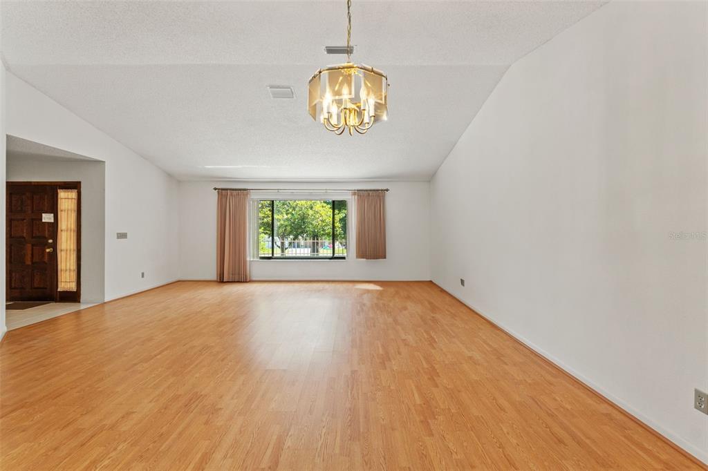 1379 Matthew Avenue Spring Hill, FL 34609 - Photo 8 of 55 an empty room with windows and chandelier fan