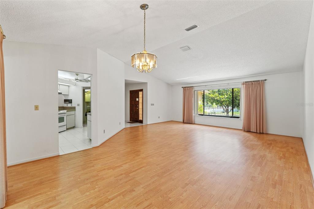 1379 Matthew Avenue Spring Hill, FL 34609 - Photo 10 of 55 a view of an empty room with window and wooden floor