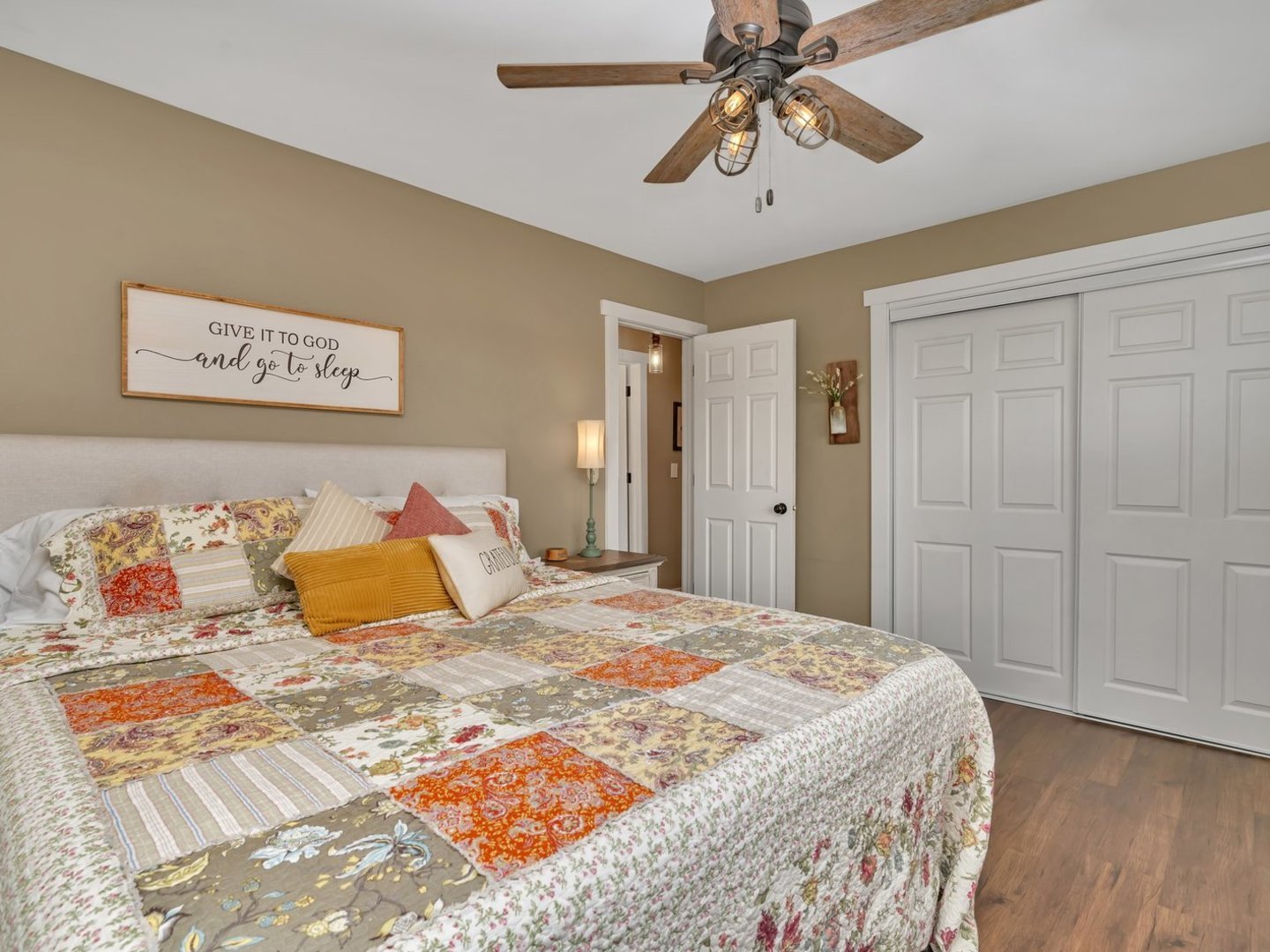 1070 West Kennedy Road Braidwood, IL 60408 - Photo 12 of 33 a bedroom with a large bed and a chandelier