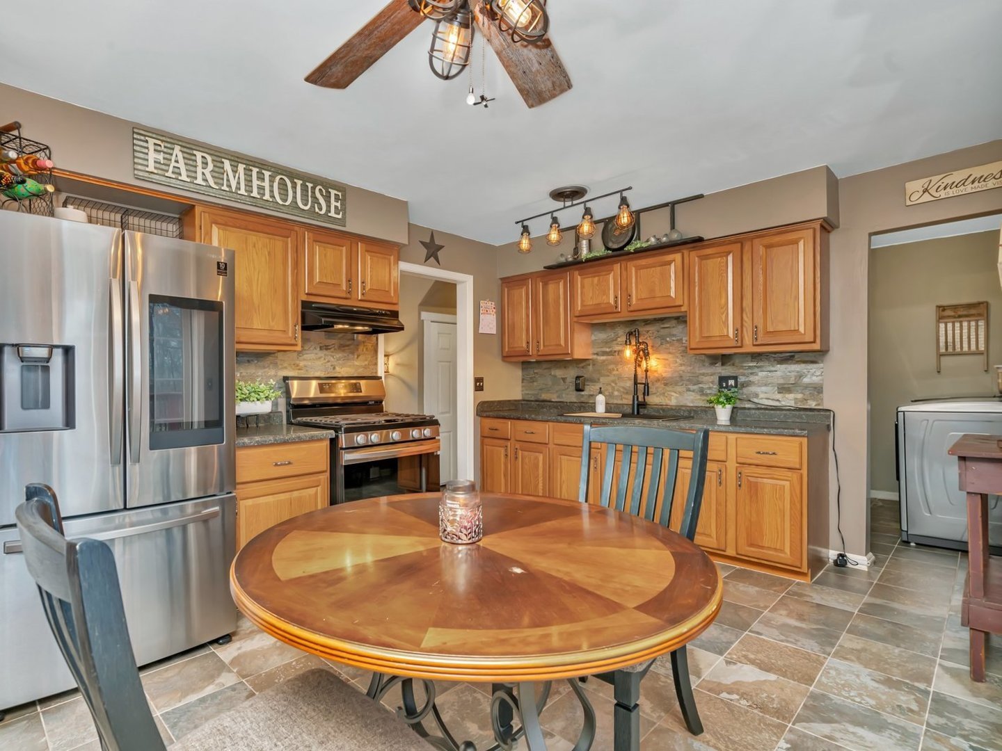 1070 West Kennedy Road Braidwood, IL 60408 - Photo 6 of 33 a kitchen with stainless steel appliances granite countertop a sink a stove a refrigerator cabinets and chairs