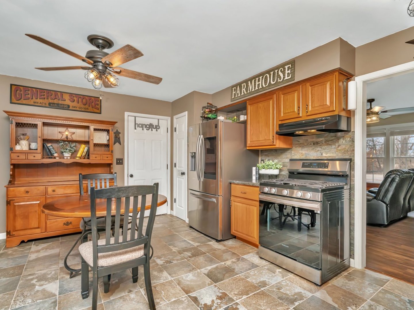 1070 West Kennedy Road Braidwood, IL 60408 - Photo 10 of 33 a kitchen with stainless steel appliances kitchen island granite countertop dining table chairs cabinets and a window