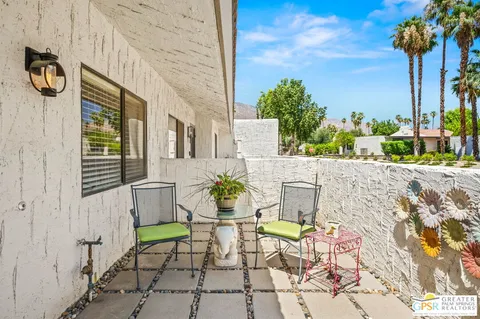 a view of a patio with table and chairs and potted plants
