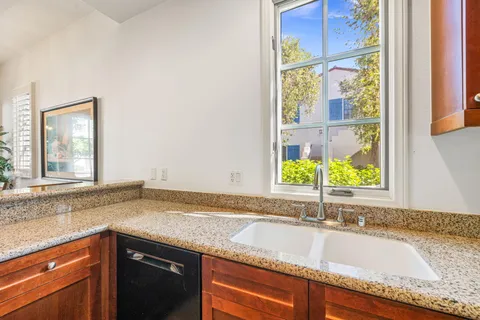 a large bed sitting in a spacious bedroom next to a window