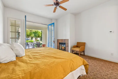 a bathroom with a granite countertop sink a toilet and a mirror