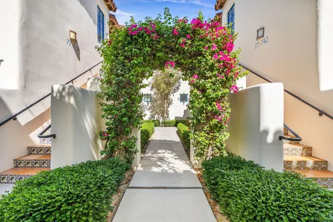 a view of an outdoor dining space with a table and chairs