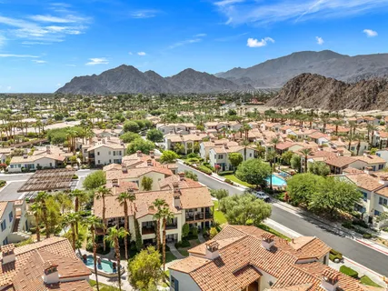 a view of a fountain in front of a brick house