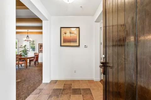 a living room with furniture a fireplace and wooden floor