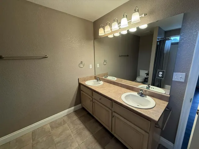 a bathroom with a sink vanity and a mirror