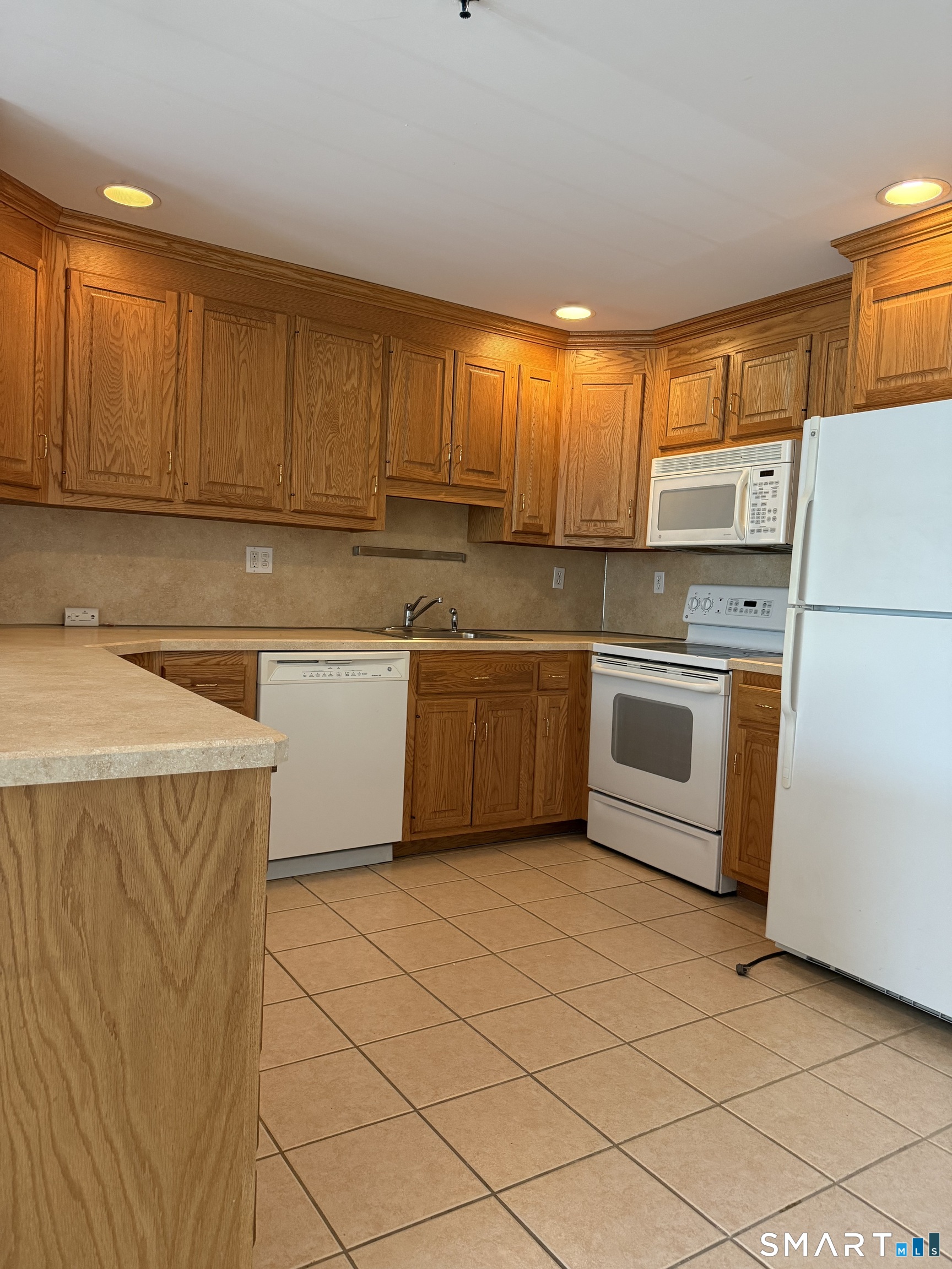 380 Main Street, Unit 16 Wallingford, CT 06492 - Photo 2 of 12 a kitchen with a stove a sink dishwasher and a refrigerator