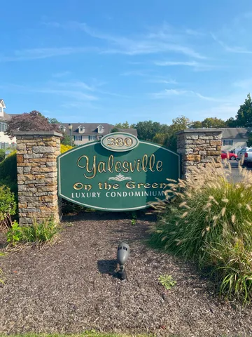 a sign board with a play ground in the back
