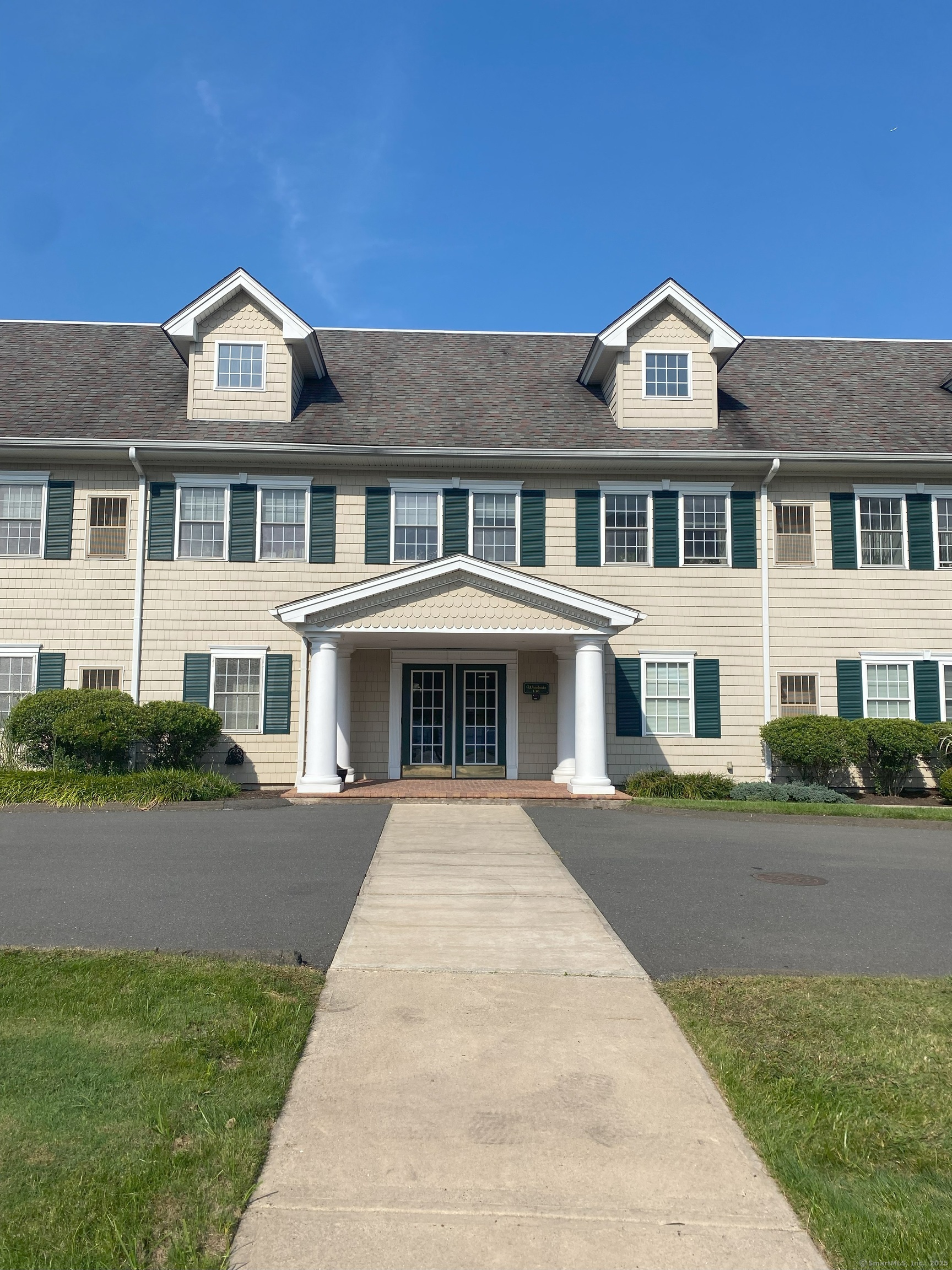 380 Main Street, Unit 16 Wallingford, CT 06492 - Photo 9 of 12 a front view of a house with a yard