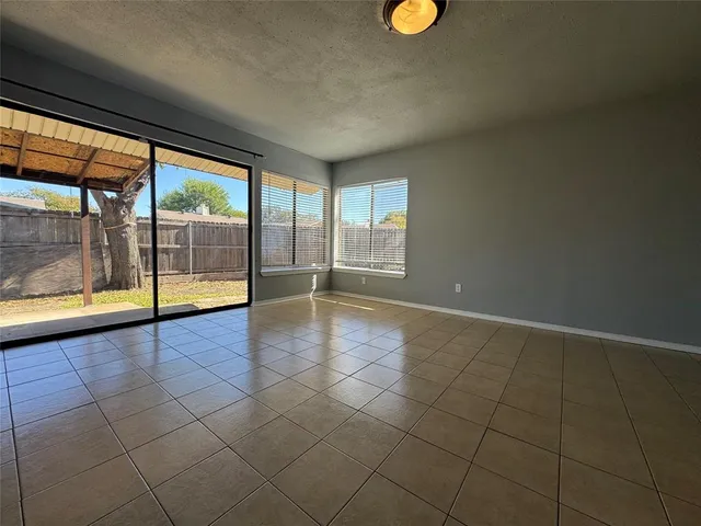 a view of an empty room with kitchen