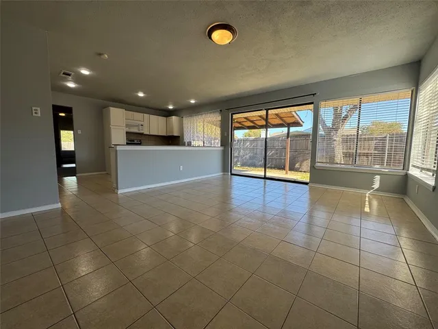 a kitchen with granite countertop a stove sink and cabinets