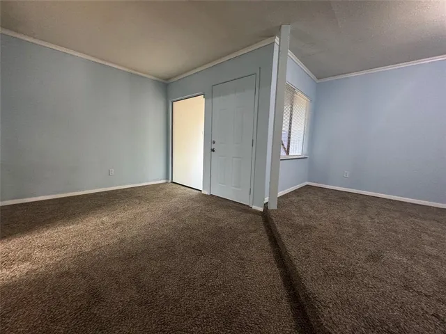 an empty room with a empty space and windows