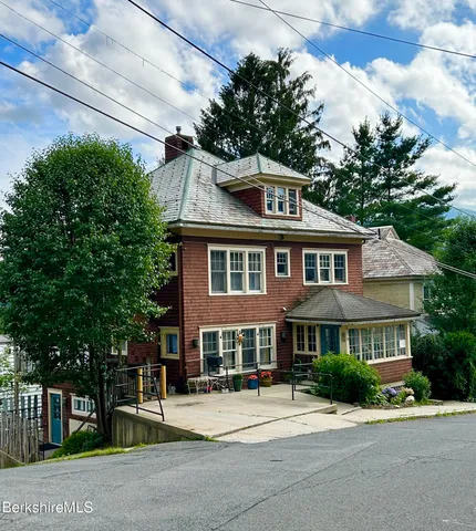 a front view of a house with a garden