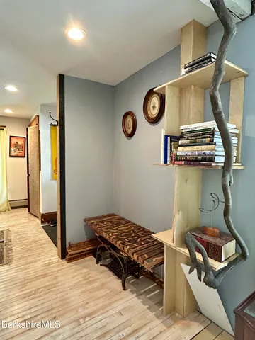 a room with a stove and a wooden floor