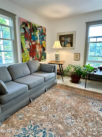 a living room with furniture and a painting