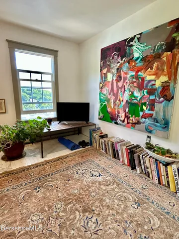 a living room with lots of furniture and a flat screen tv